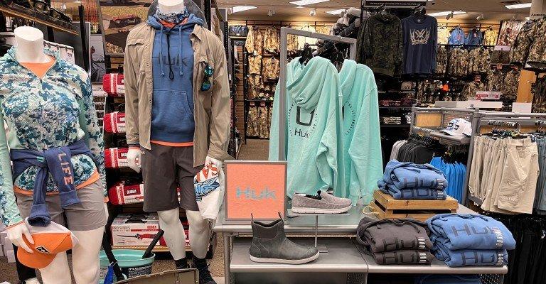 a variety of fishing clothing on display at SCHEELS