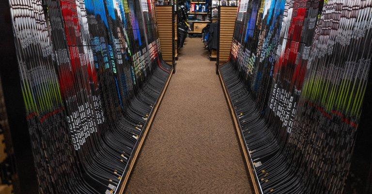 A variety of hockey sticks on display at SCHEELS.