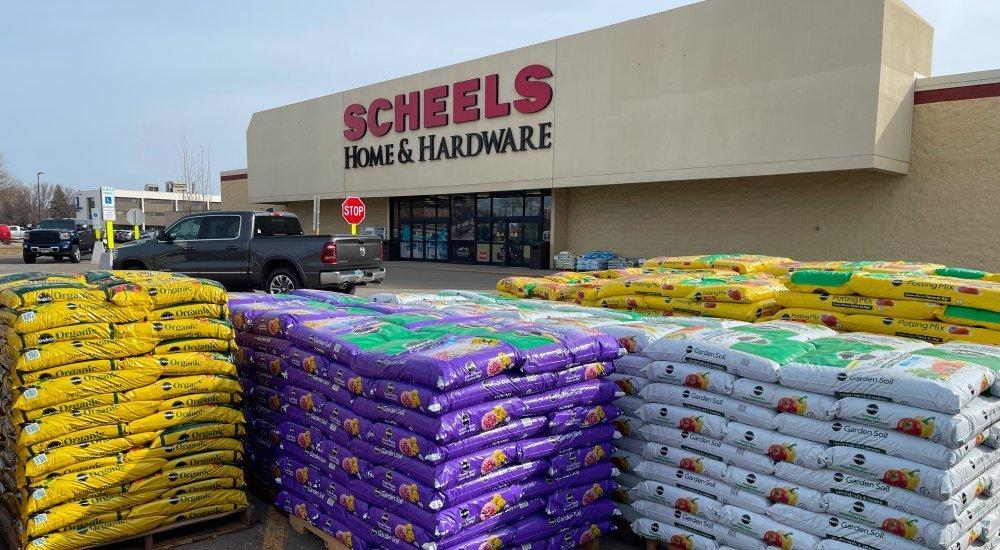 the exterior of home and hardware with bags of soil