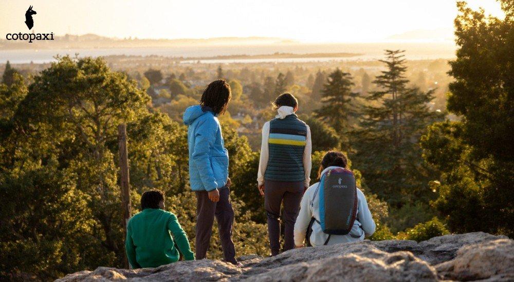 four people that reached the top of the mountain hiking