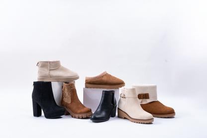 A pile of different style suede boots