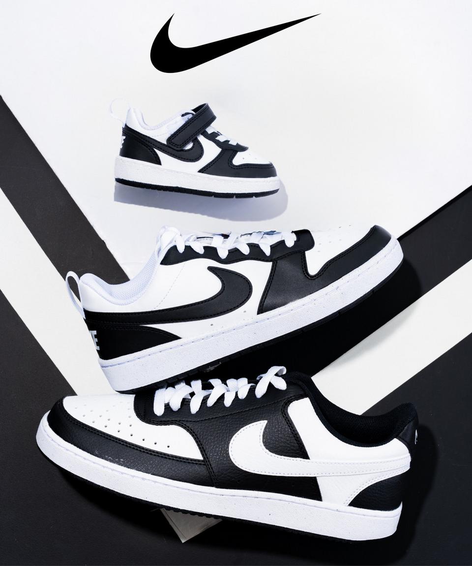 Strand out in Nike black and white court sneakers.