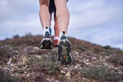 Person hiking on ridge in trail shoes
