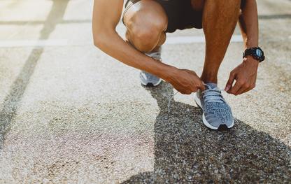 Person tying their shoe laces to go on a run