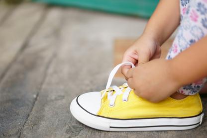 Child tying their shoes