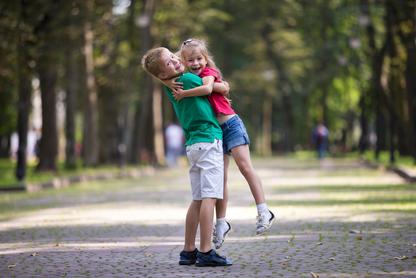 Siblings hugging in a park