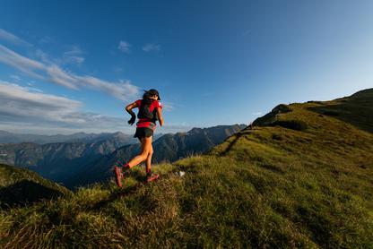 Woman running on a trial in the mountains