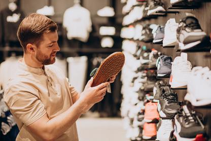 Man shopping for shoes at a store