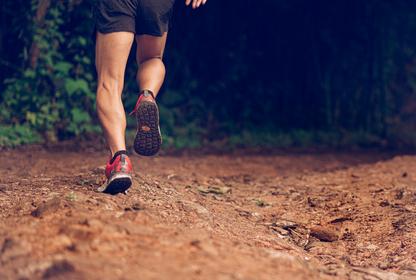 Man running on dirt trail