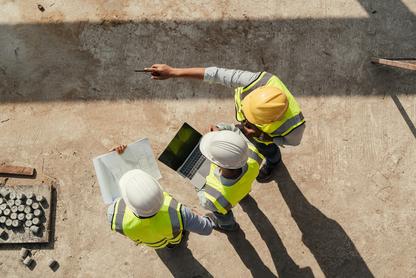 Construction workers standing on concrete