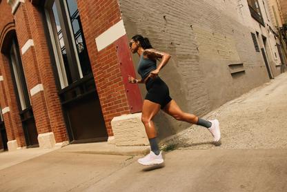 Woman running in HOKA shoes