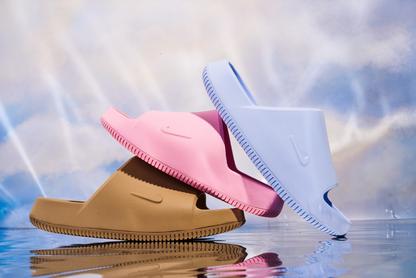 Nike Slides with a cloudy background