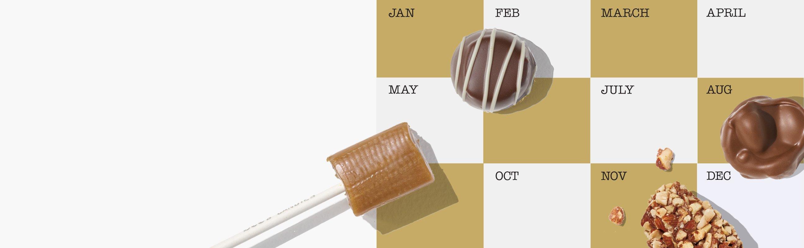 A gold and grey colored calendar showing the months is shown. A few chocolate and candy pieces are lying on top of the calendar.