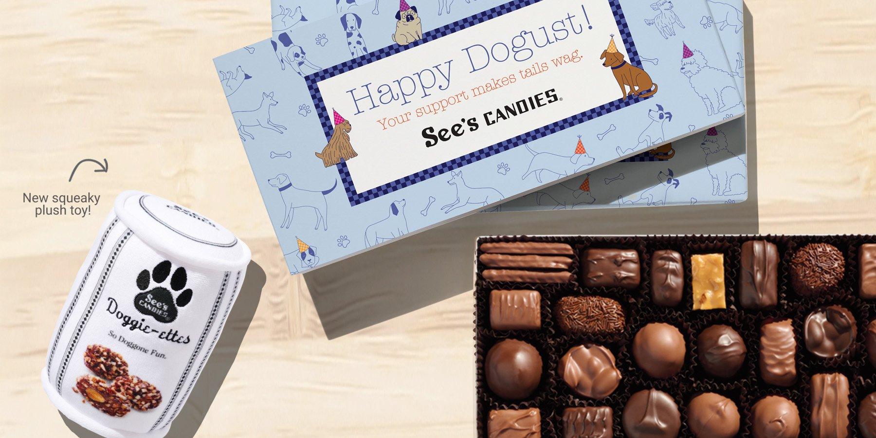 An assorted box of chocolates with a sleeve that says Happy Dogust and a plush squeaky dog toy that looks like a toffee-ettes can