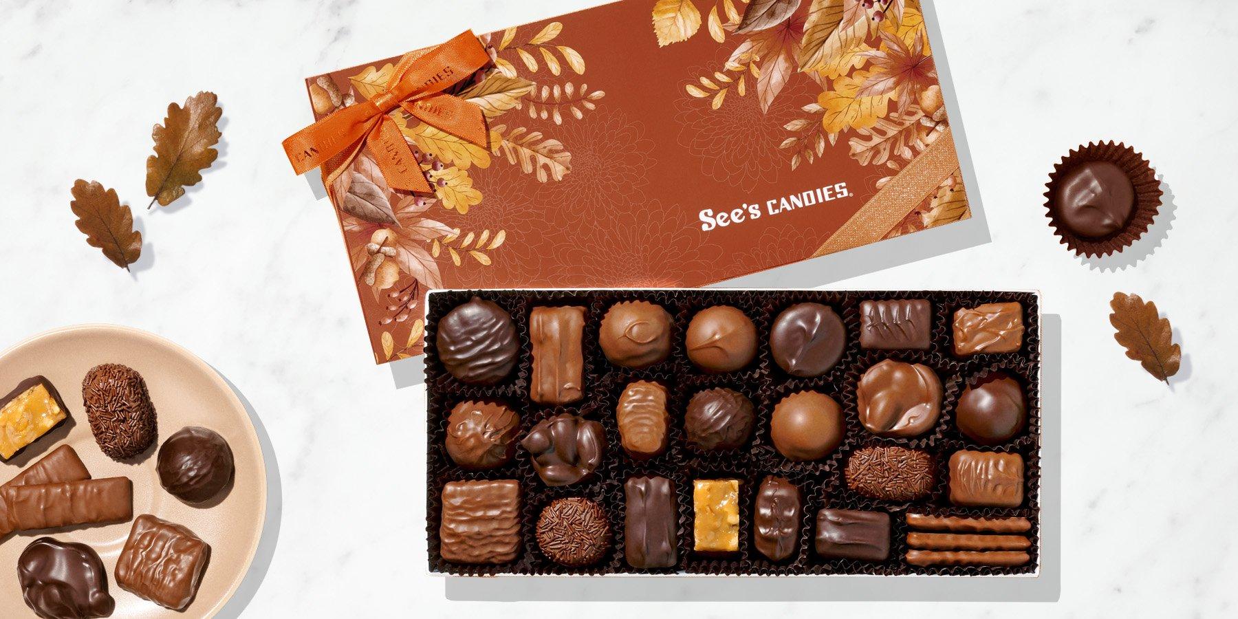 A box of chocolates with decorative fall foliage on the sleeve