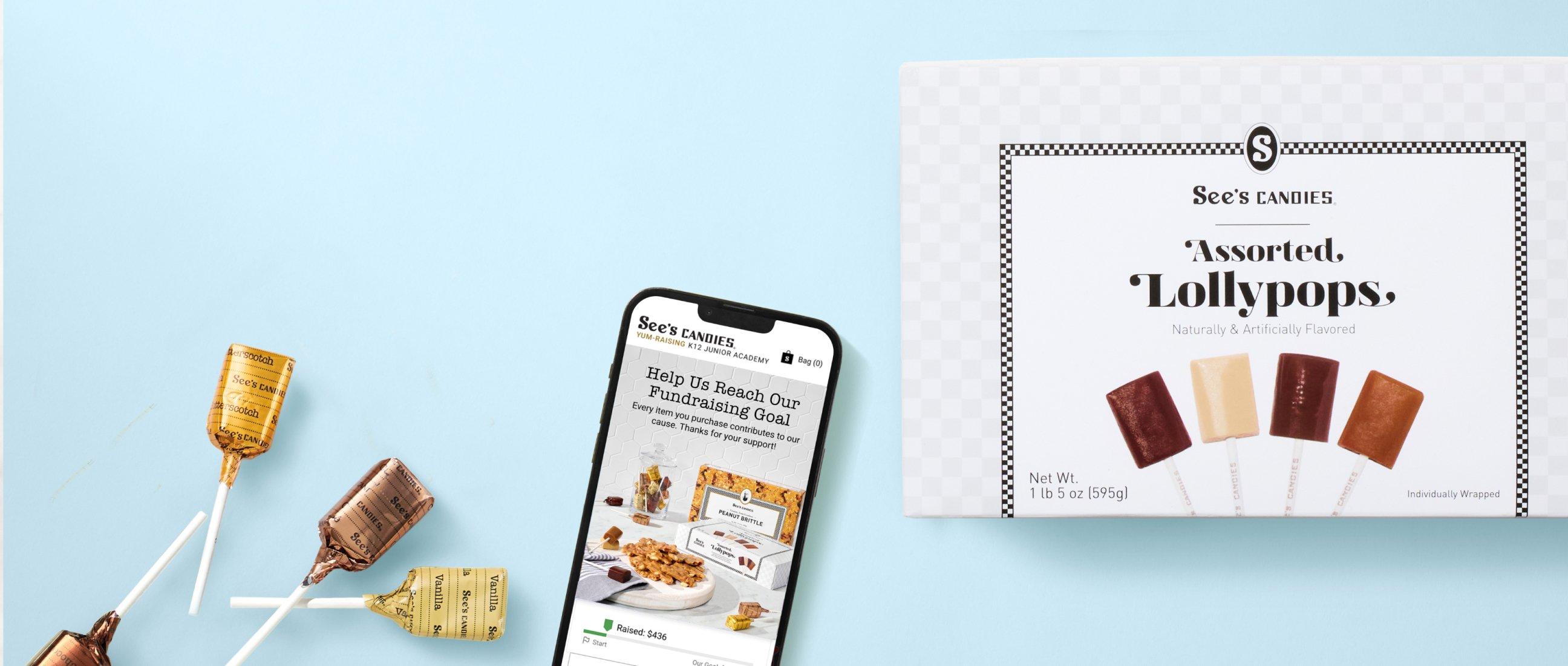 A phone screen on the See's Candies Yumraising page next to a box of lollypops on a blue background.
