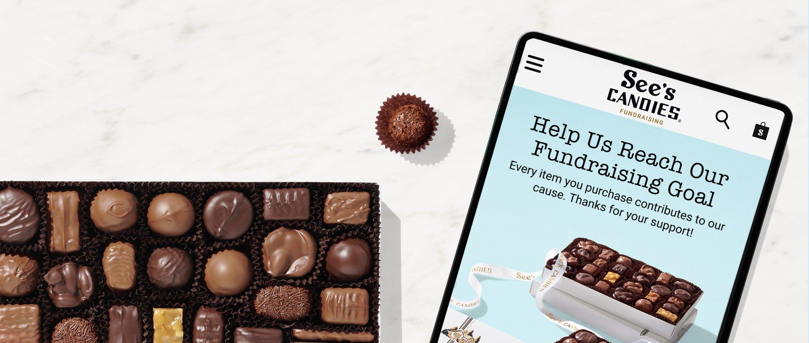A tablet featuring a Yumraising storefront that says "Help Us Reach Our Fundraising Goal"