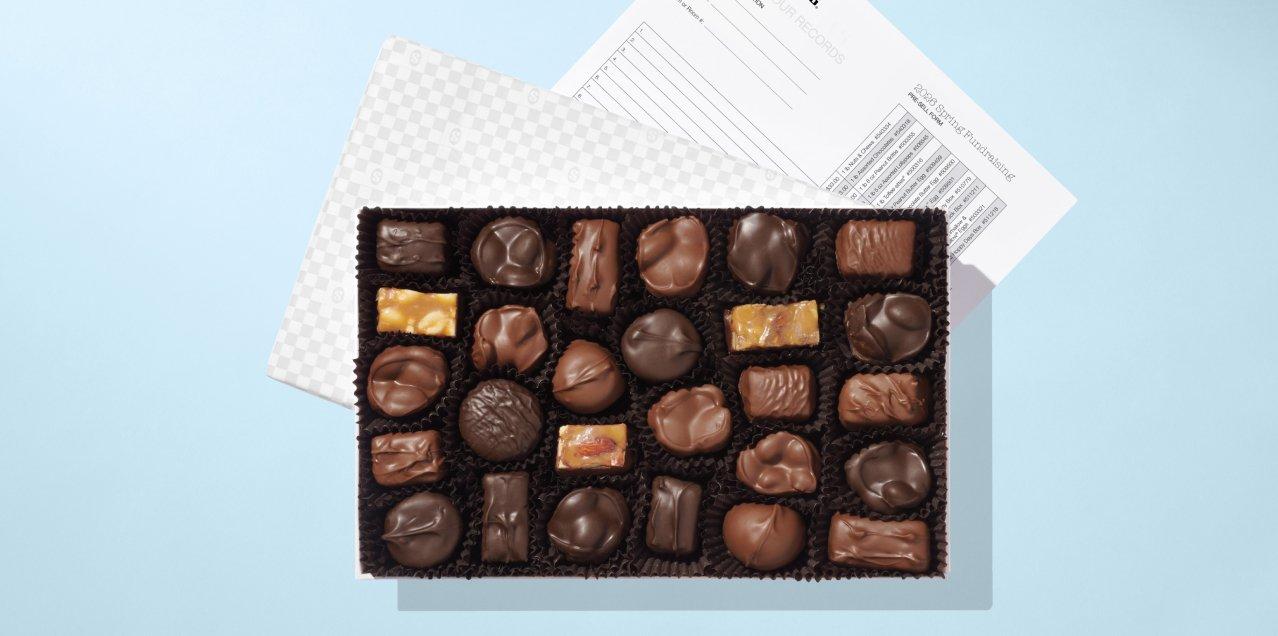 A box of chocolates with order forms