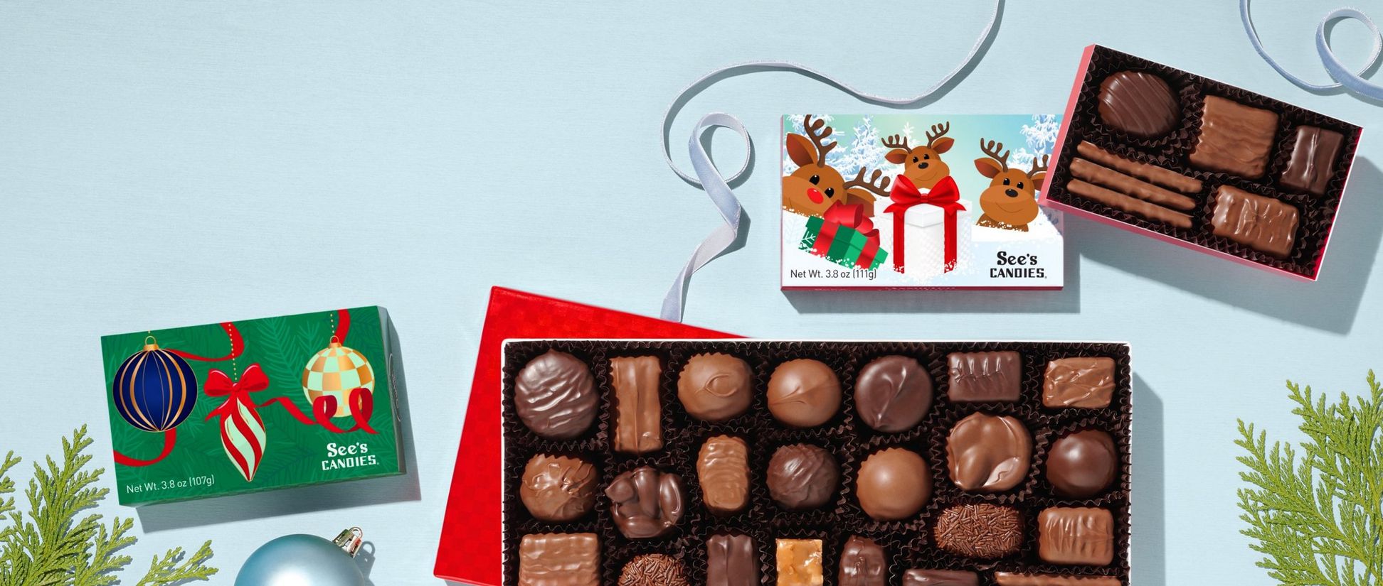 Christmas themed chocolate boxes on a blue background