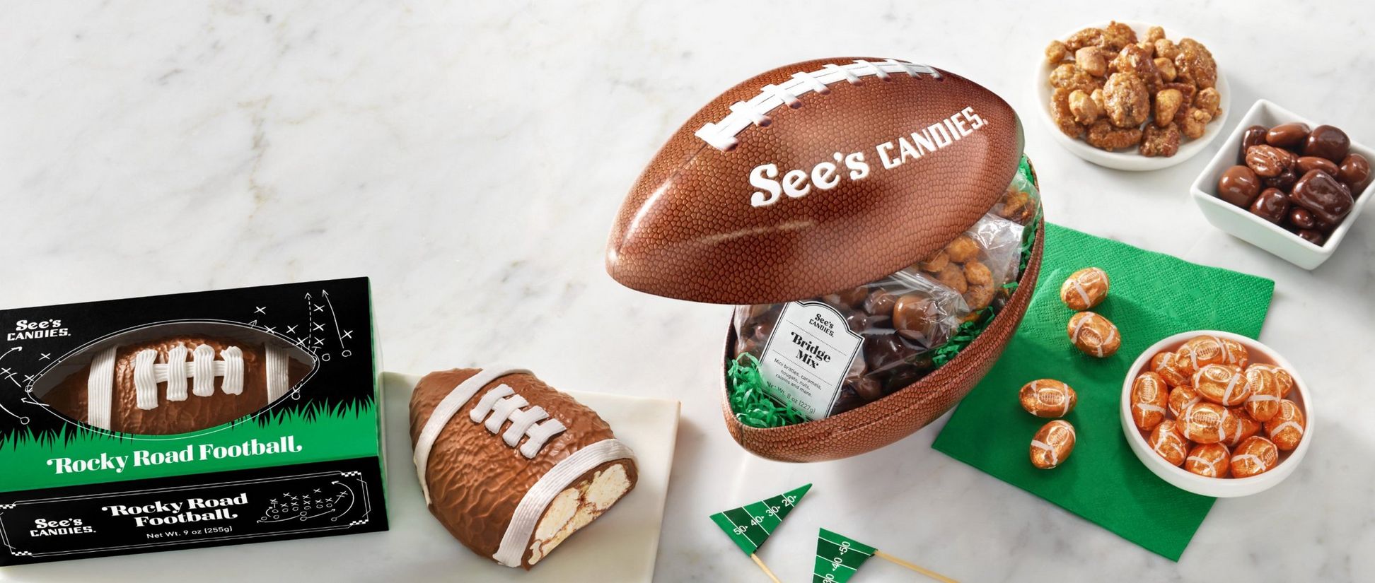Array of See's Candies Game Day treats including Snack Attack Tin with Praline Pecans and more
