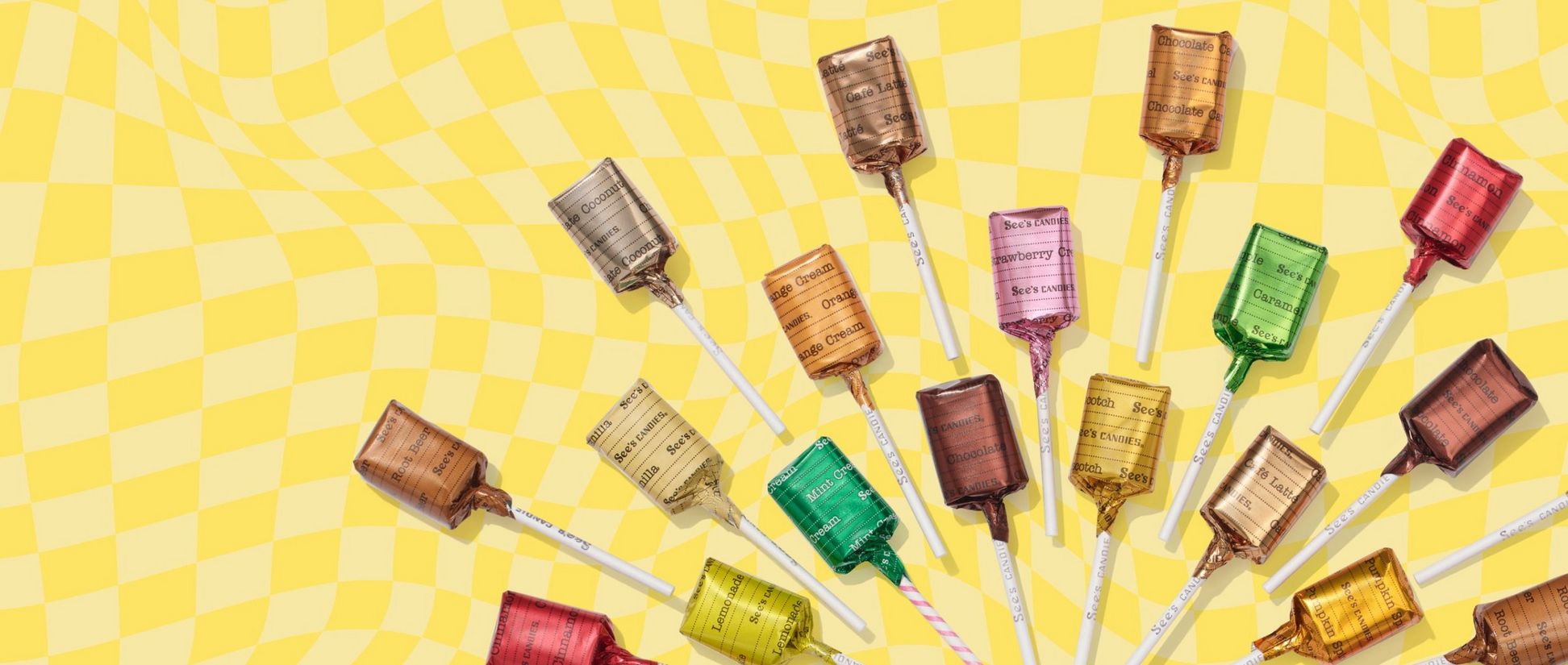 An array of colorful lollypops on a yellow checkered background