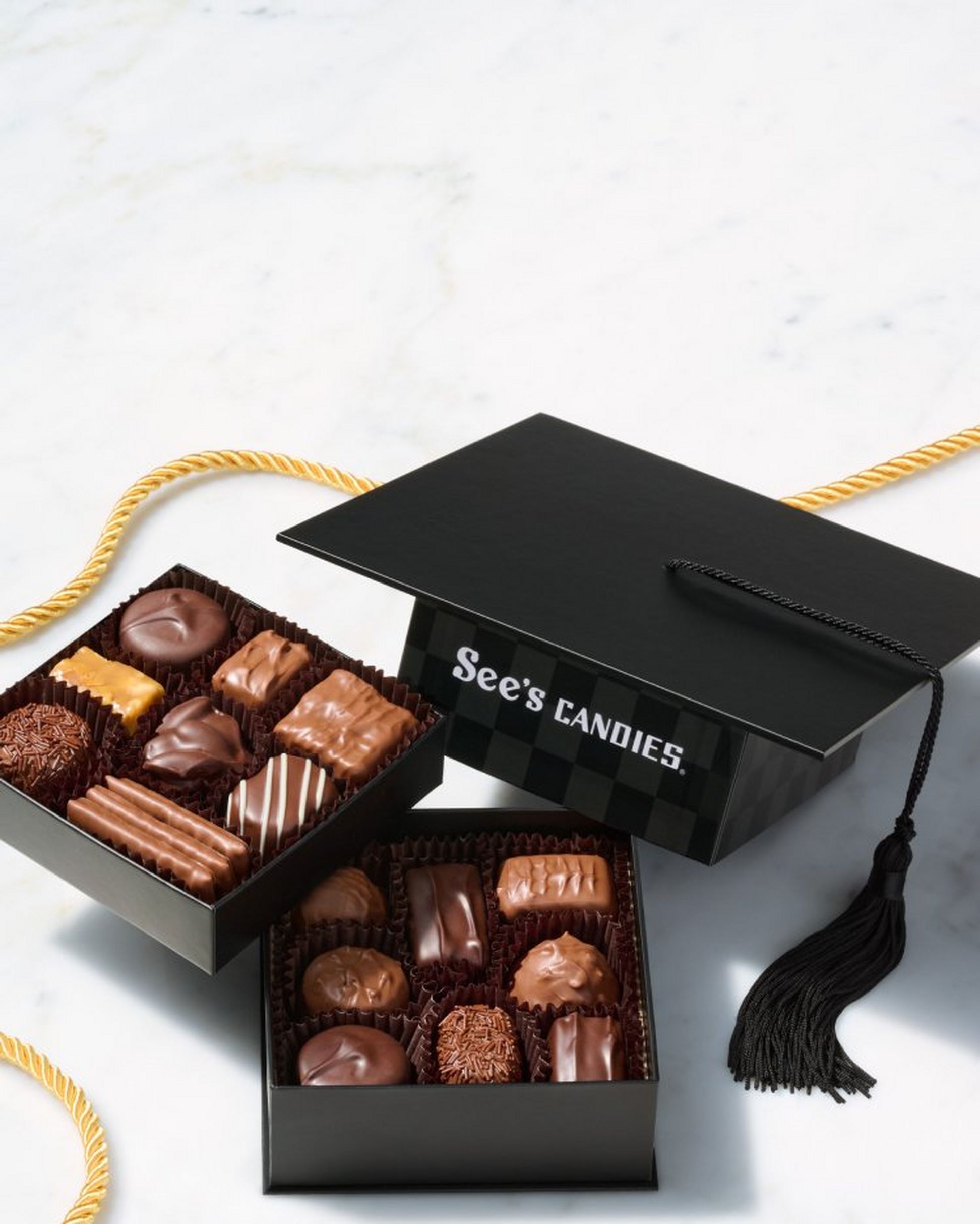 A Graduation Hat shaped chocolate box with two layers of chocolates.