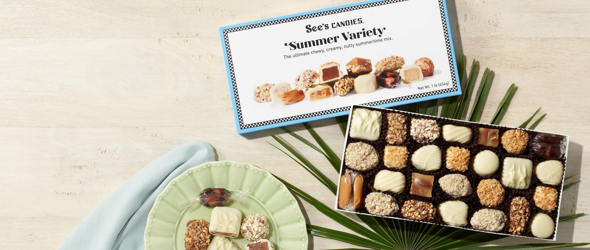 An assorted box of chocolates featuring summer flavors and some loose candy pieces