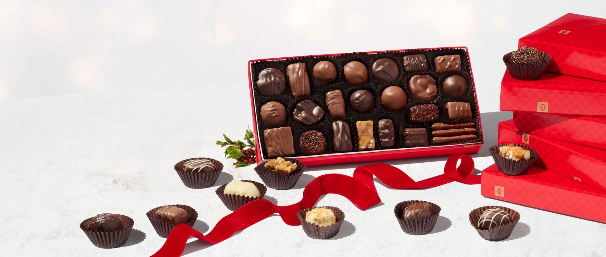 See's Candies boxed chocolates in red wrap.