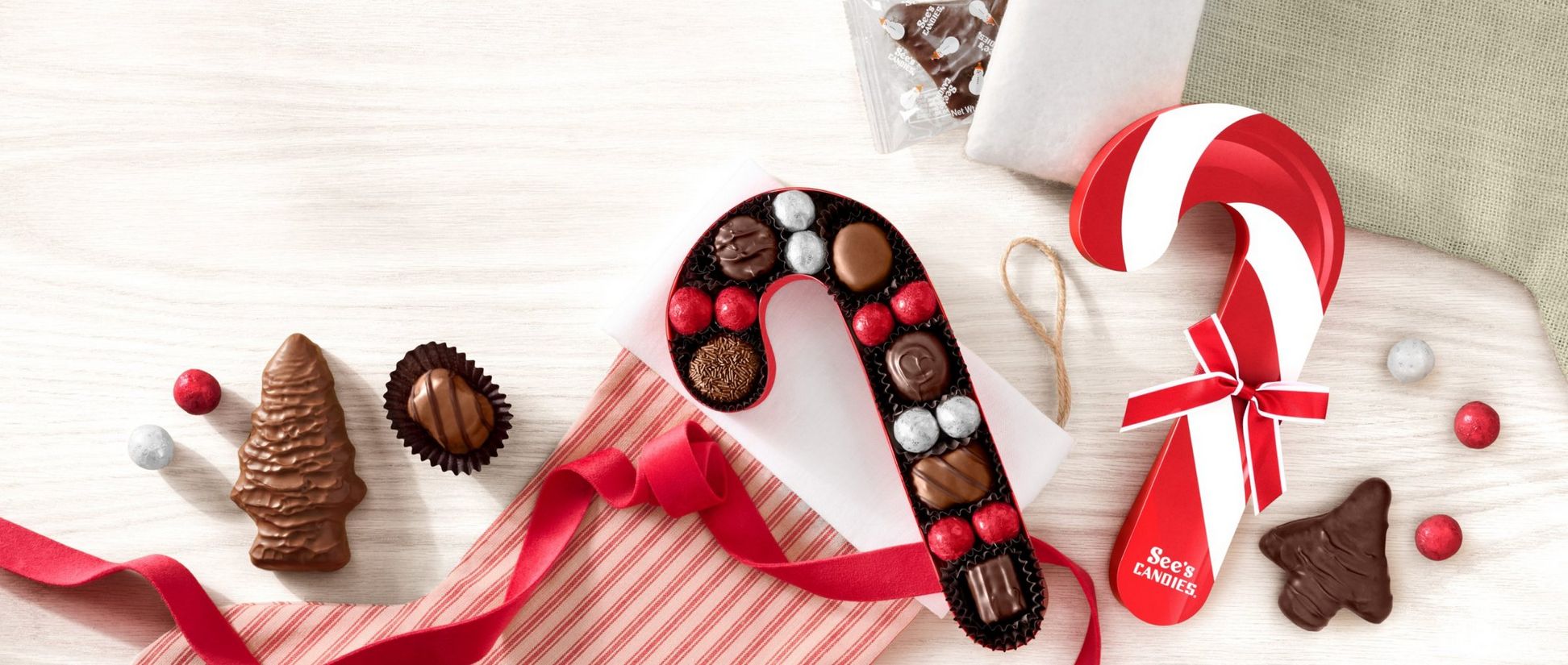 A candy cane-shaped chocolate box with stockings