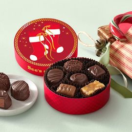 A small round chocolate box with stocking decoration