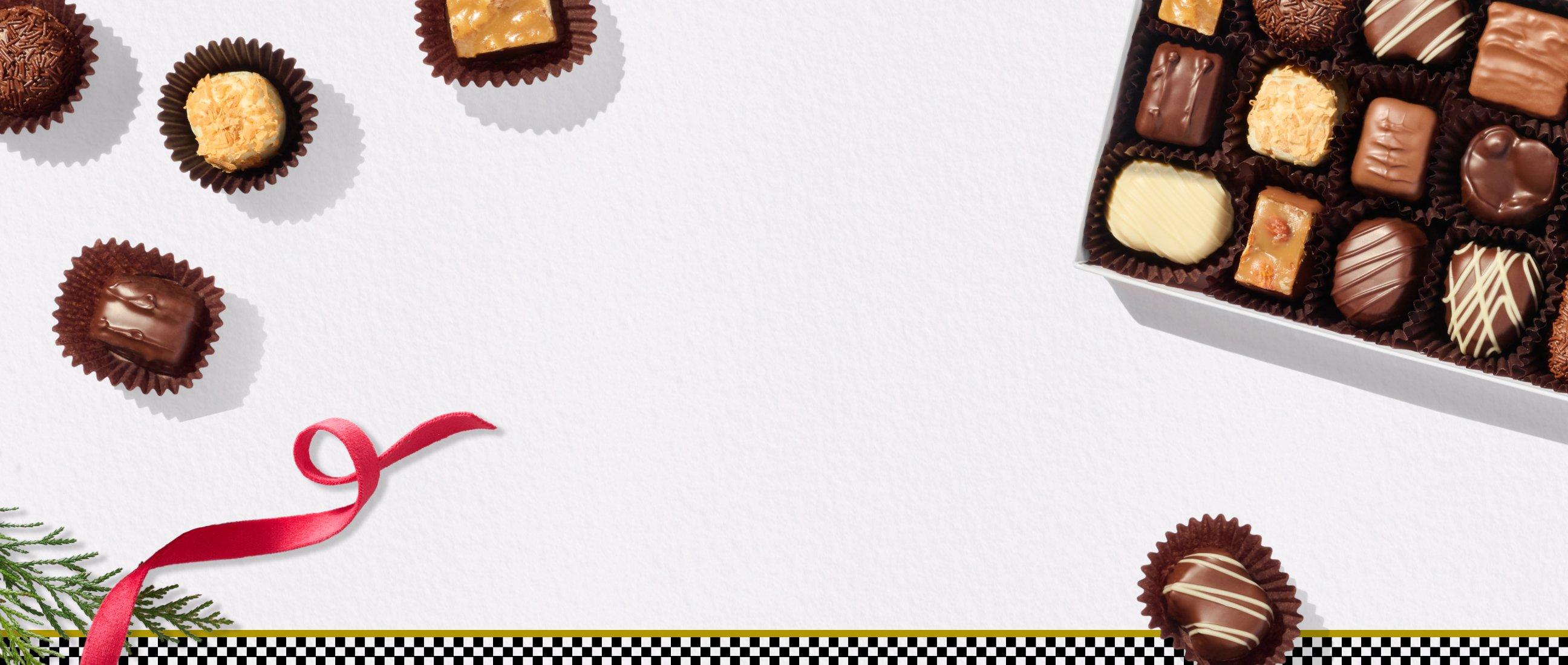 Assortment of See's Candies chocolates with a checkered banner at the bottom with a red ribbon as an accent mark