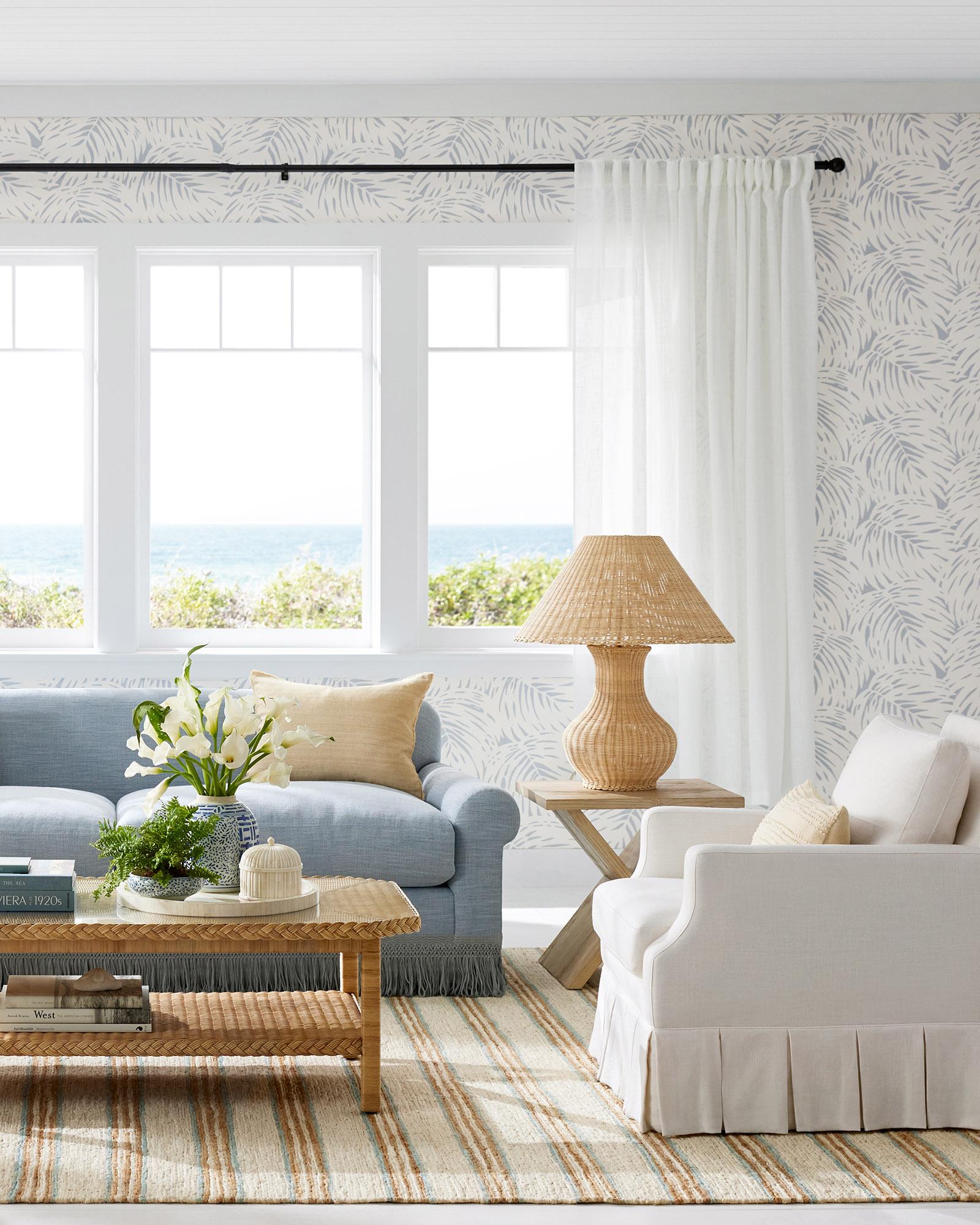 LivingRoomCoastalBlueSofaCambridgeFringePalmWallpaperbrand