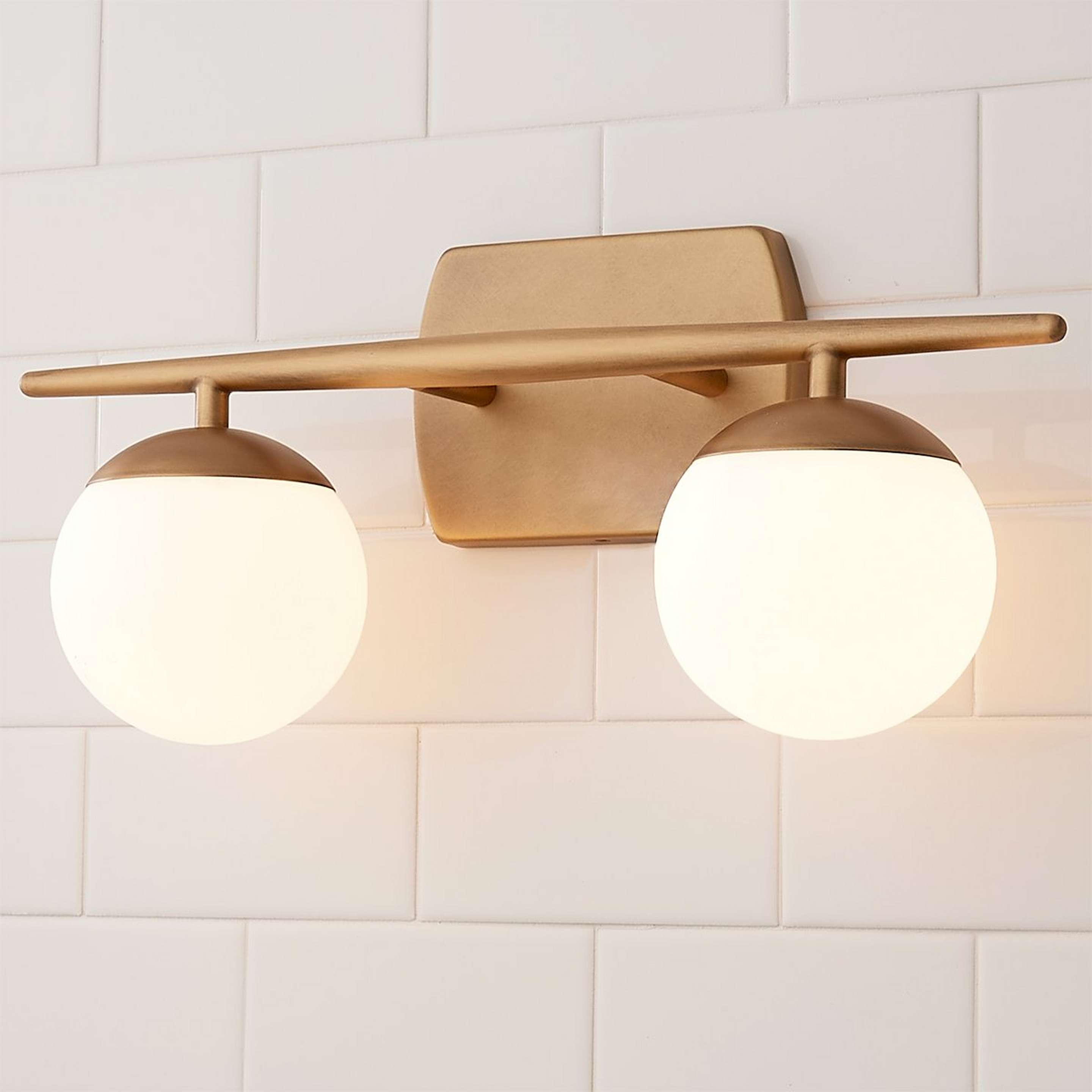 A Linear Globe Vanity Light - 2 Light with Natural Brass color