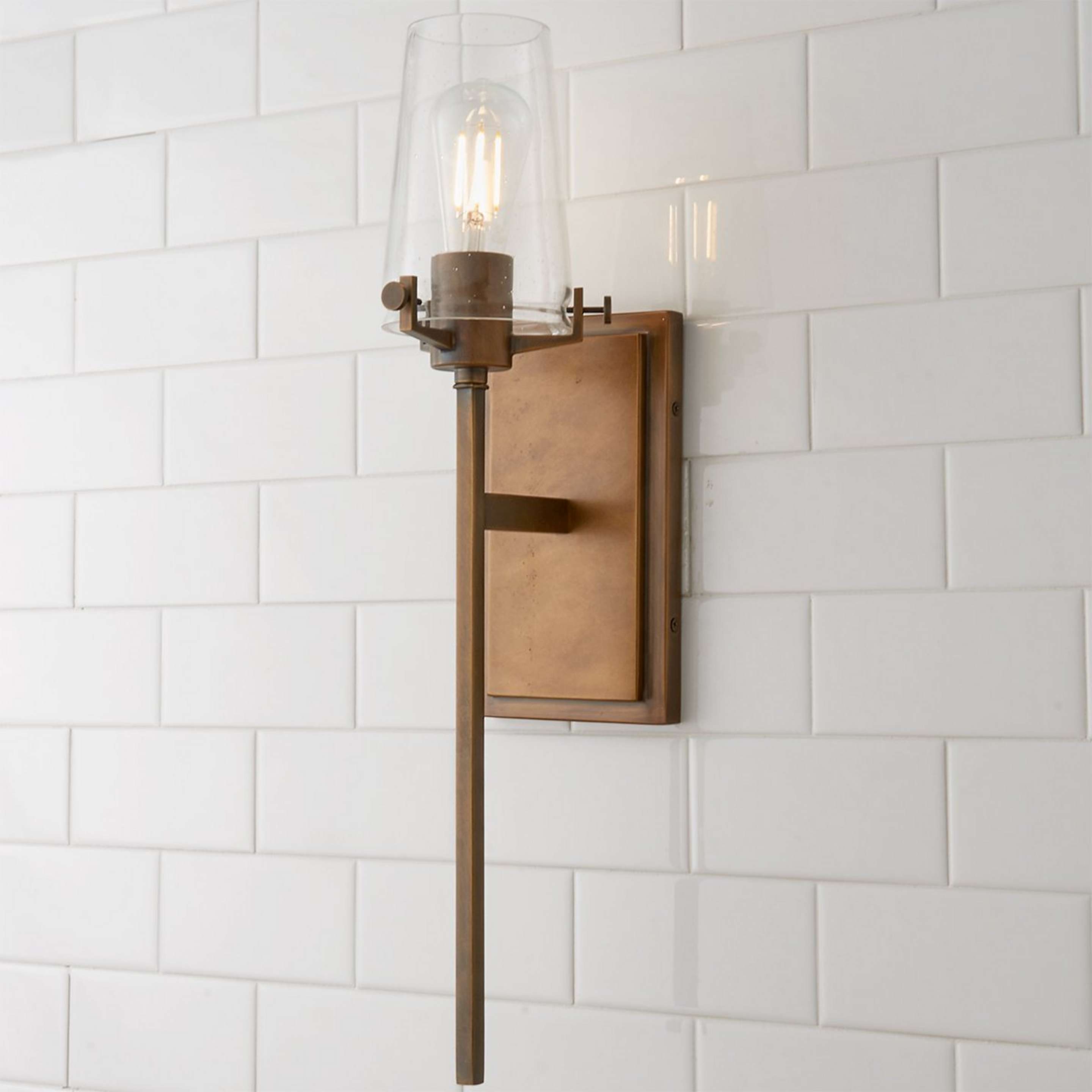 A Modern Industrial Seeded Glass Sconce with Natural Brass color