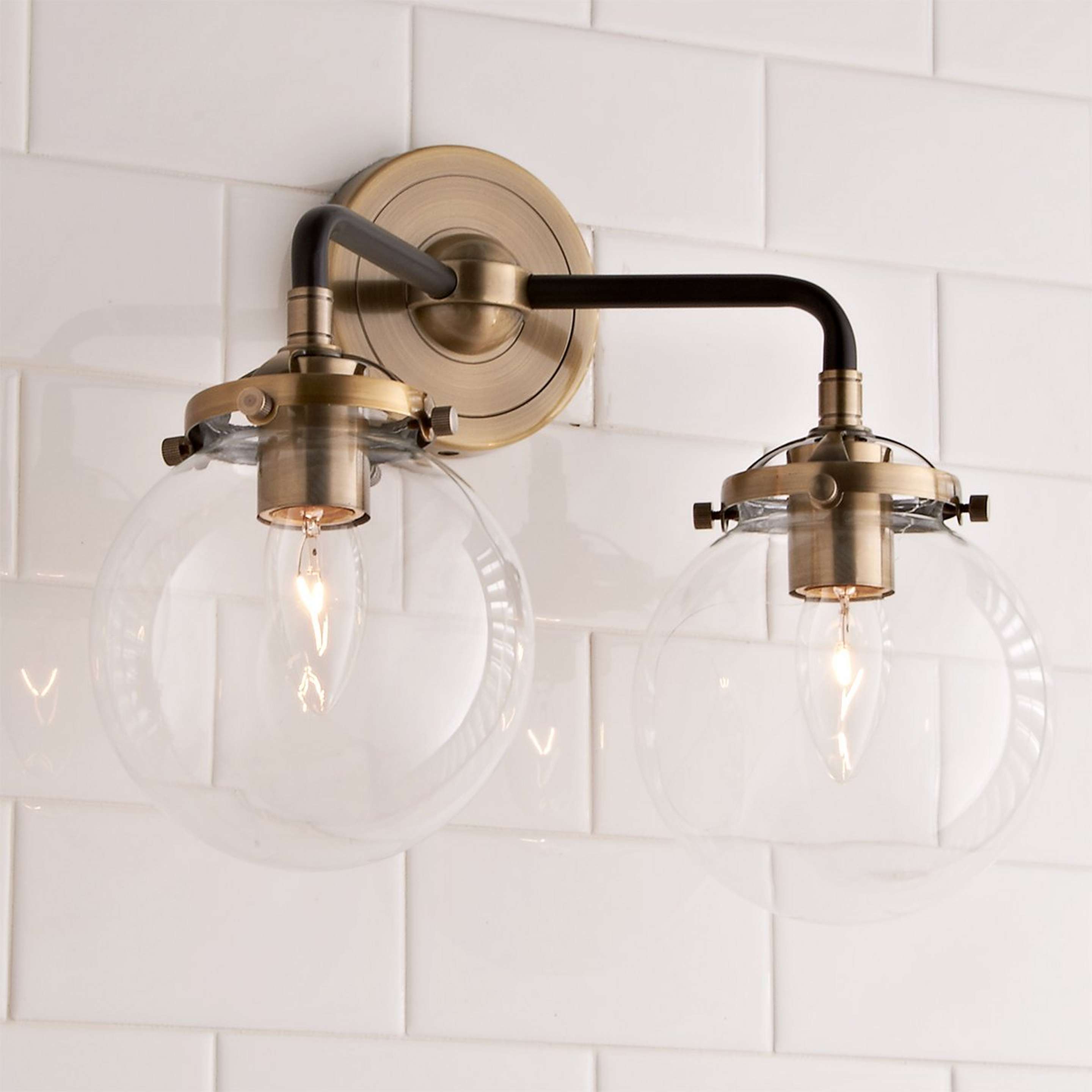 A Mod Mix Clear Globe Vanity Light - 2 light with Antique Brass / Black / Clear Glass color