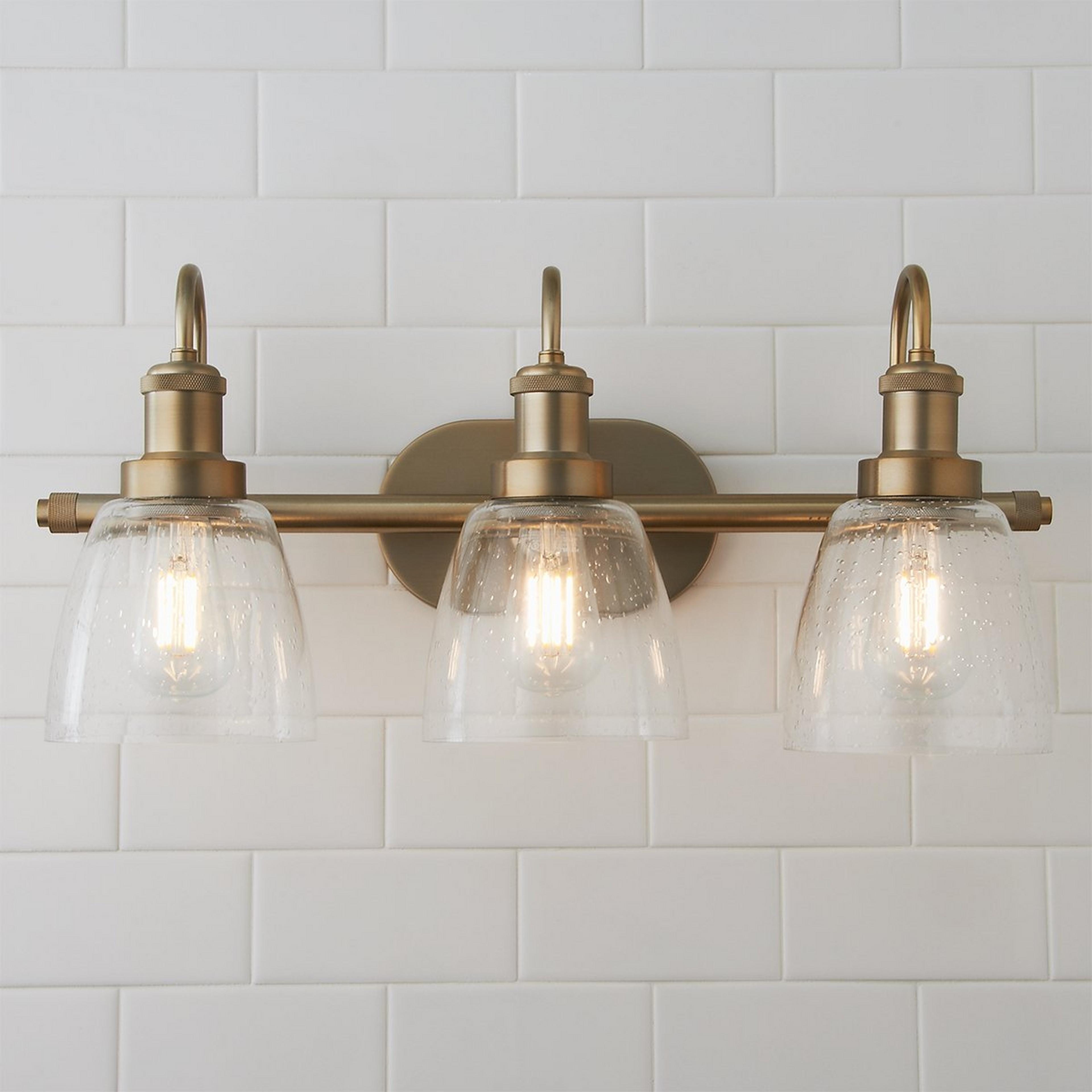 A Versatile Vanity Light - 3 Light with Aged Brass / Clear color