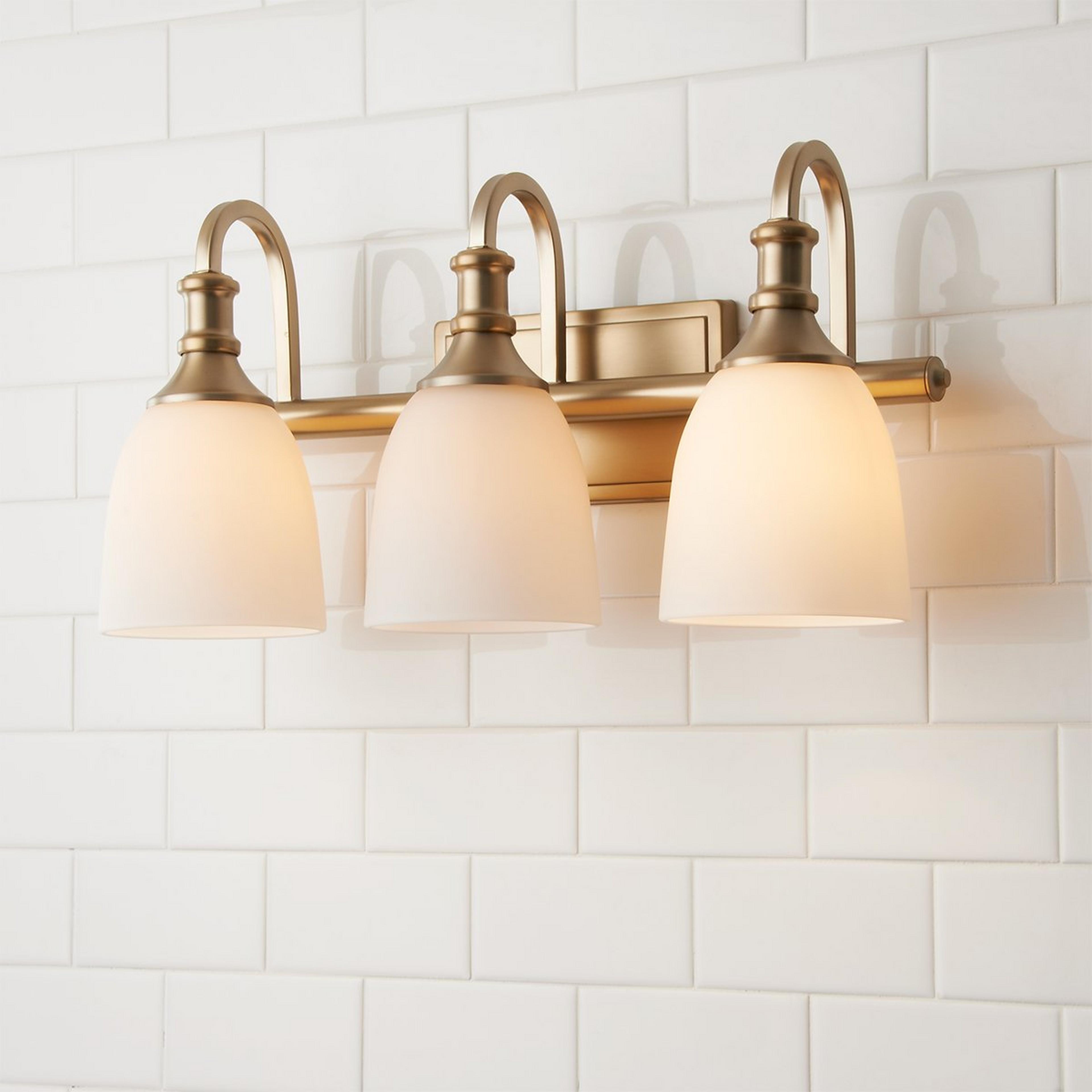 A Modern Progression Vanity Light - 3 Light with Aged Brass / Opal color