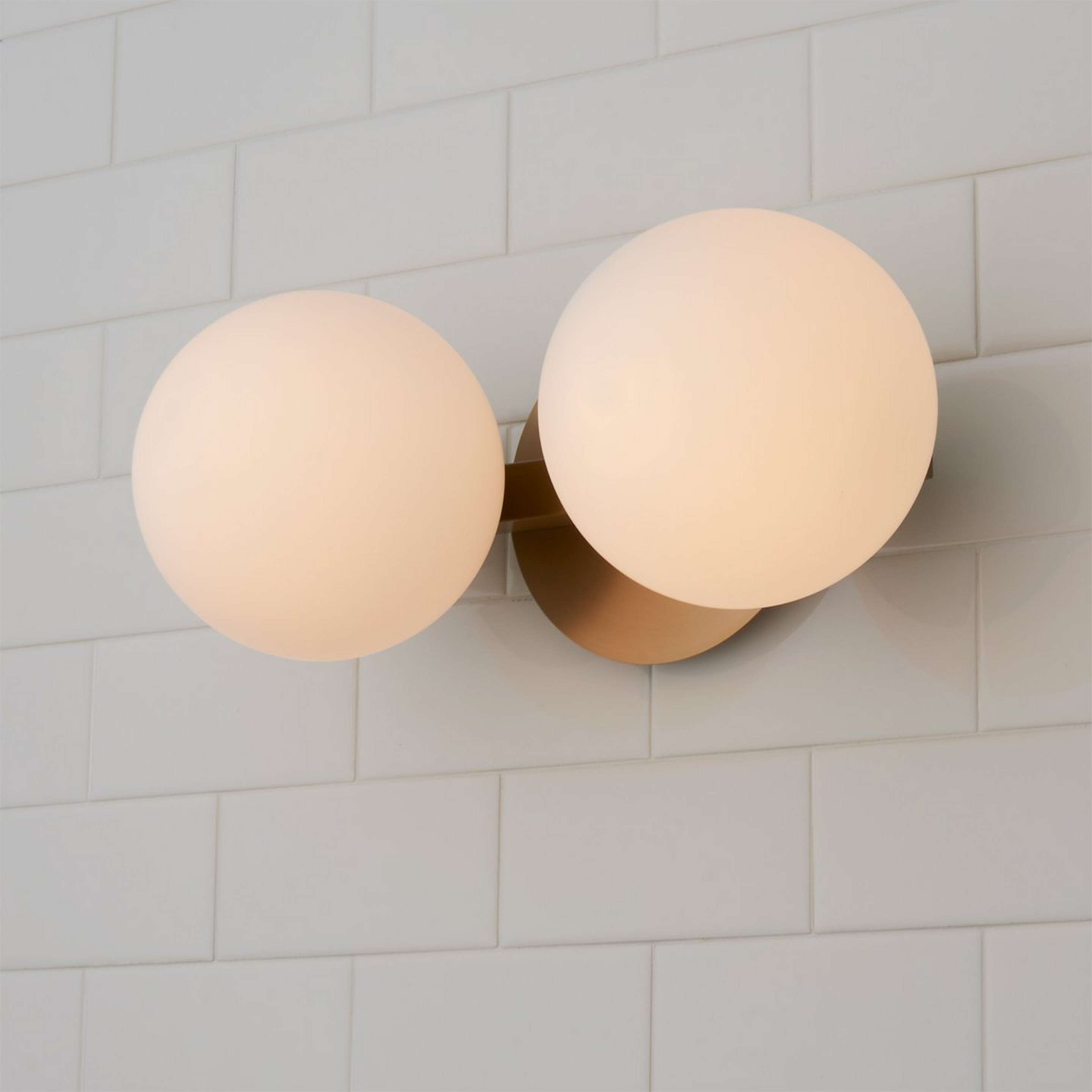 A Modern Milky Globe Vanity Light - 2 Light with Aged Brass / Opal color
