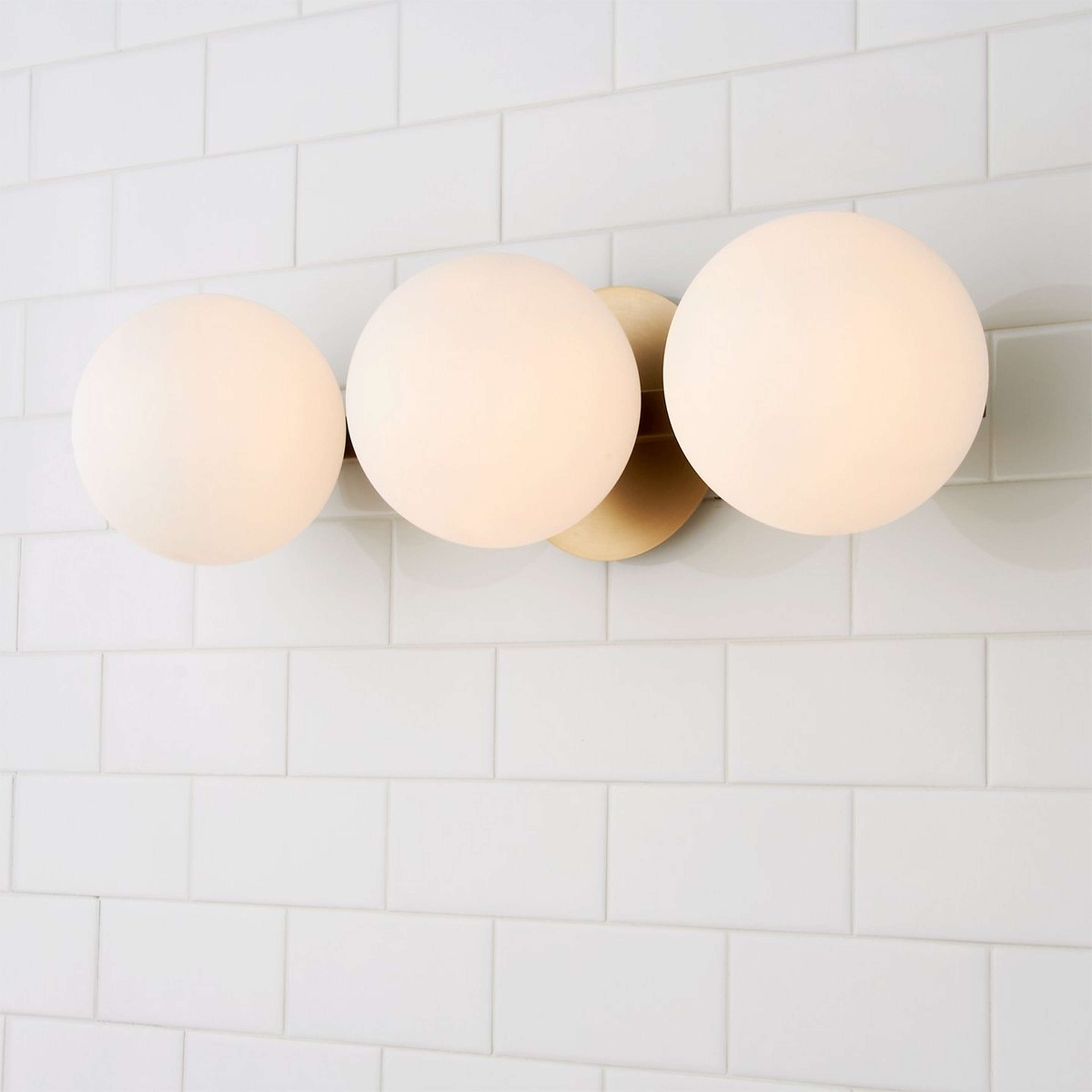 A Modern Milky Globe Vanity Light - 3 Light with Aged Brass / Opal color