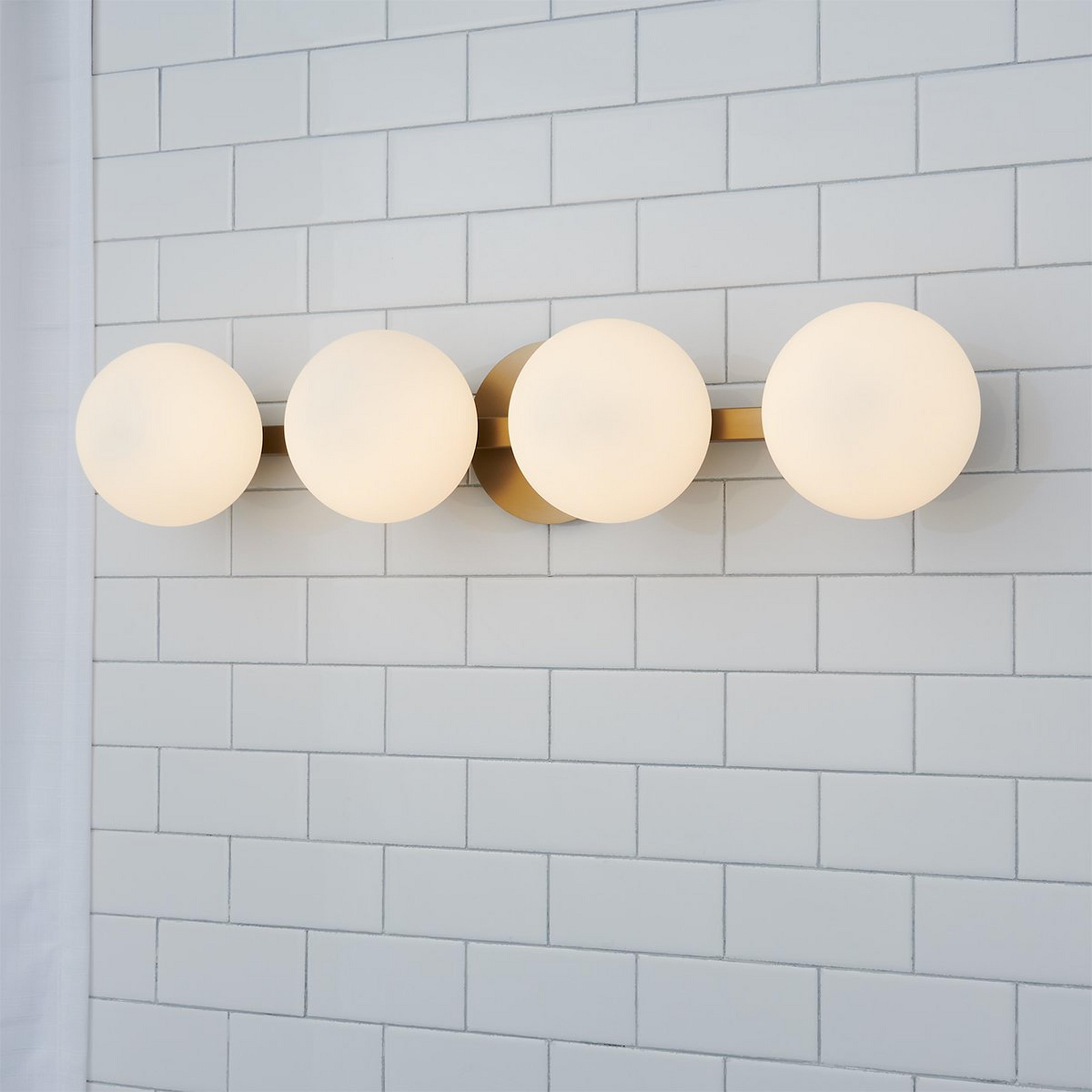 A Modern Milky Globe Vanity Light - 4 Light with Aged Brass / Opal color