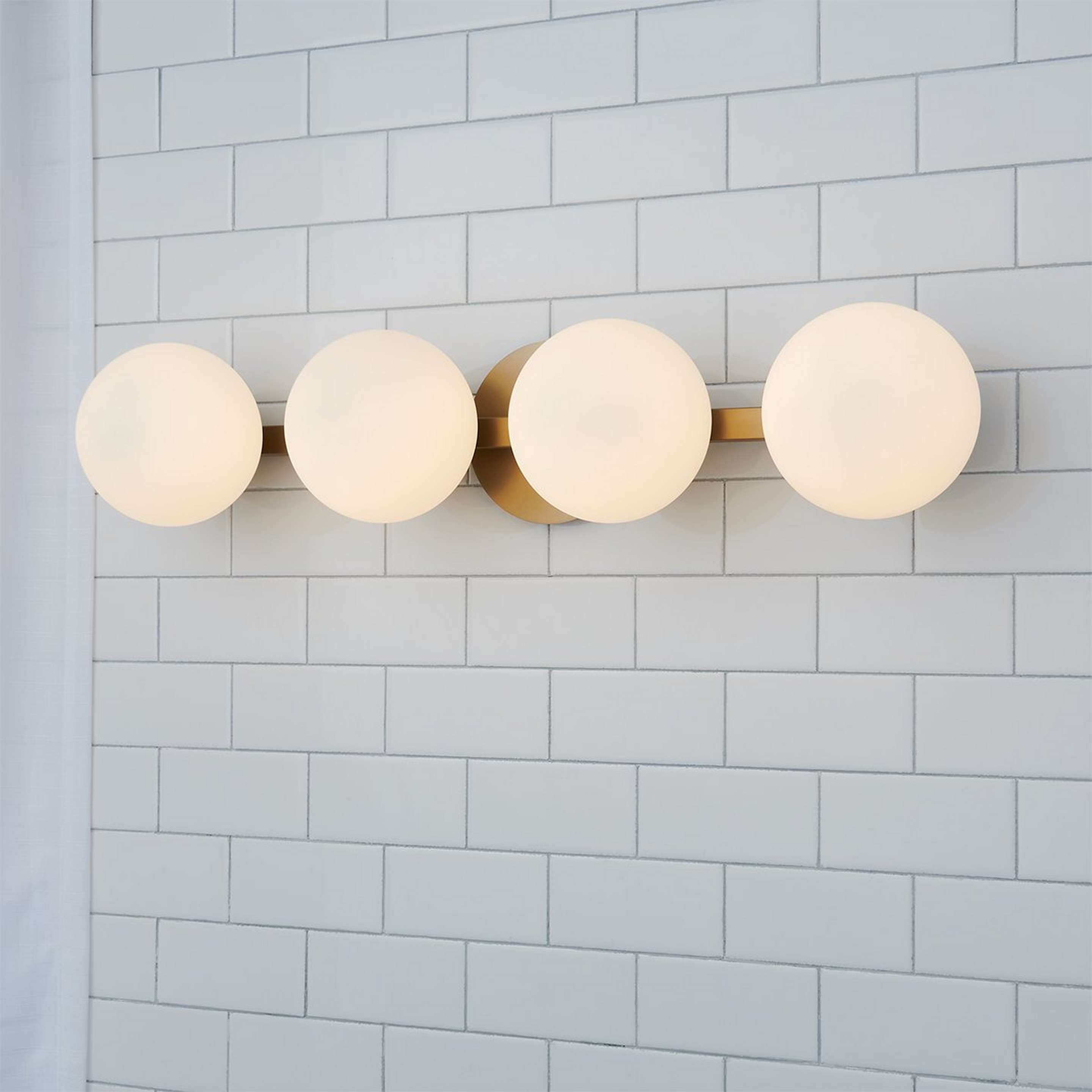 A Modern Milky Globe Vanity Light - 4 Light with Aged Brass / Opal color
