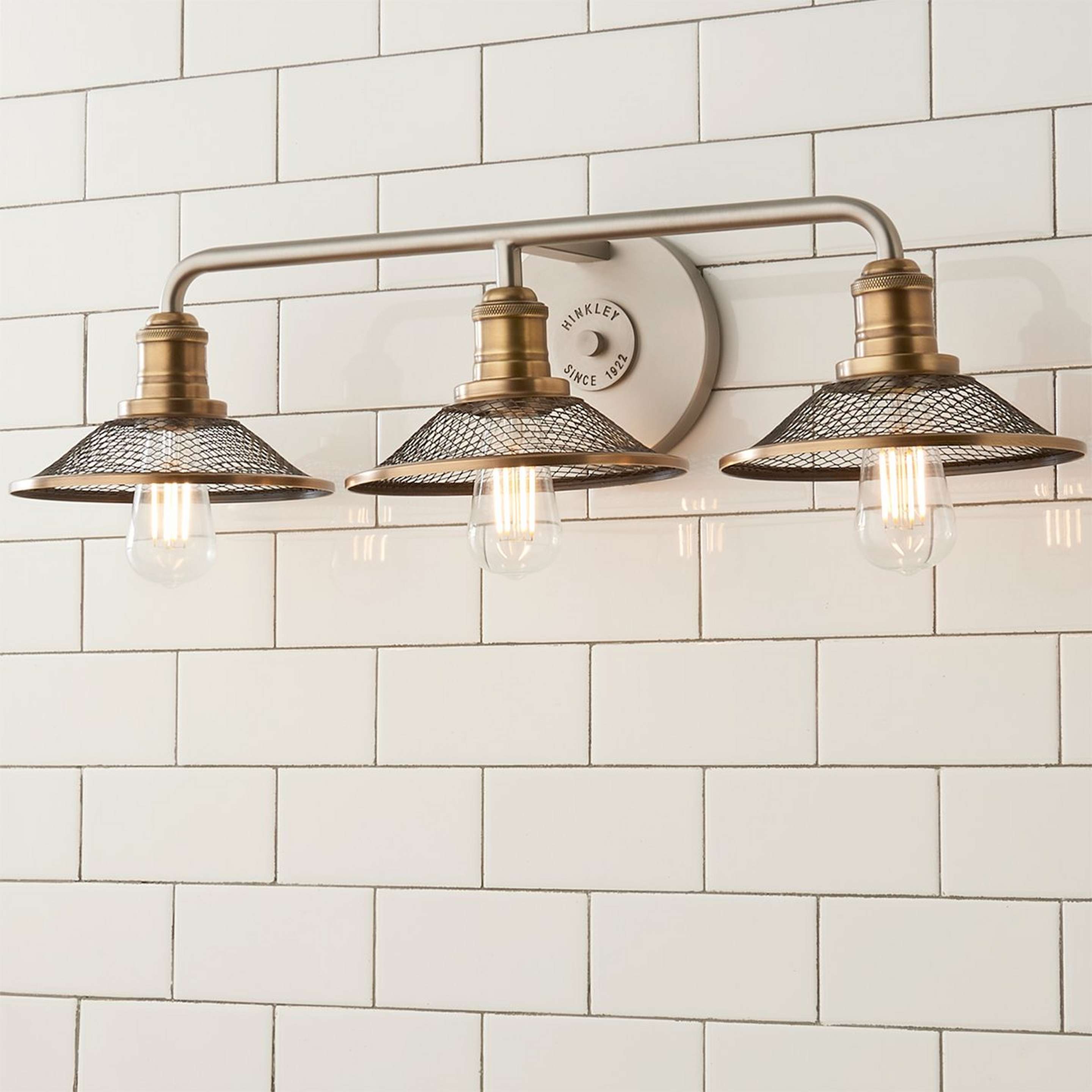 A Retro Warehouse Shade Vanity Light - 3 Light with Antique Nickel / Brass color