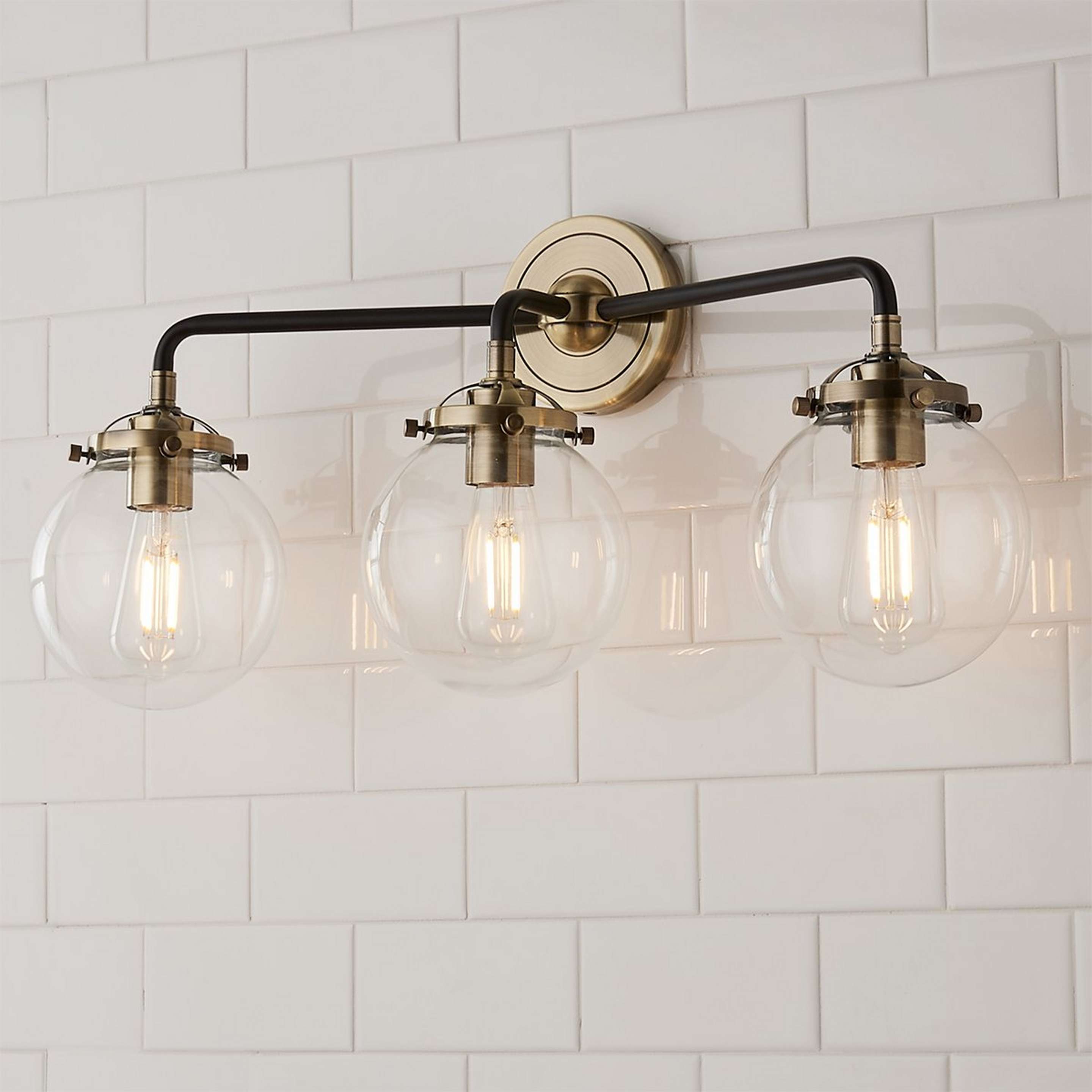A Mod Mix Clear Globe Vanity Light - 3 Light with Antique Brass / Black / Clear Glass color