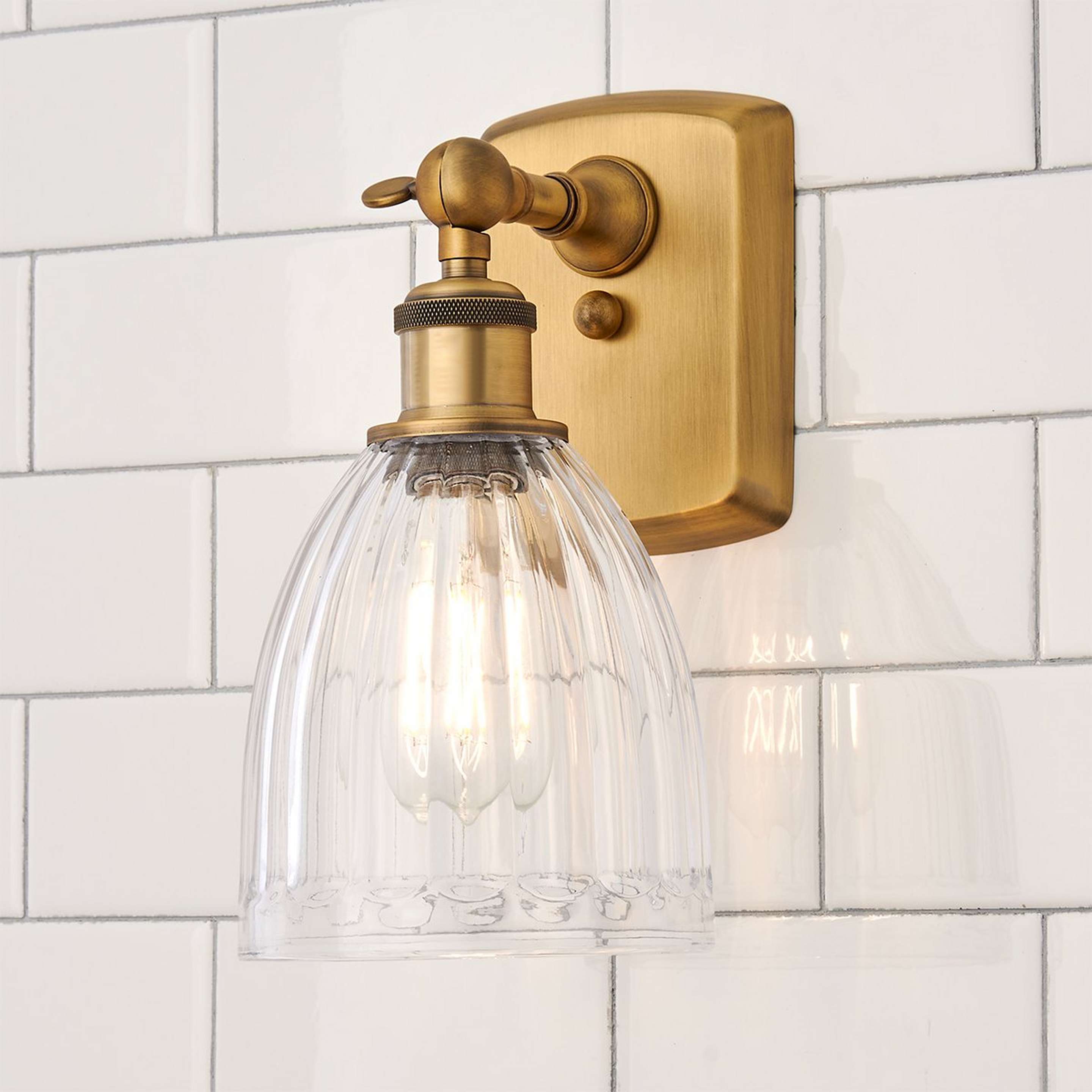 A Vintage Update Bath Sconce with Brushed Brass color