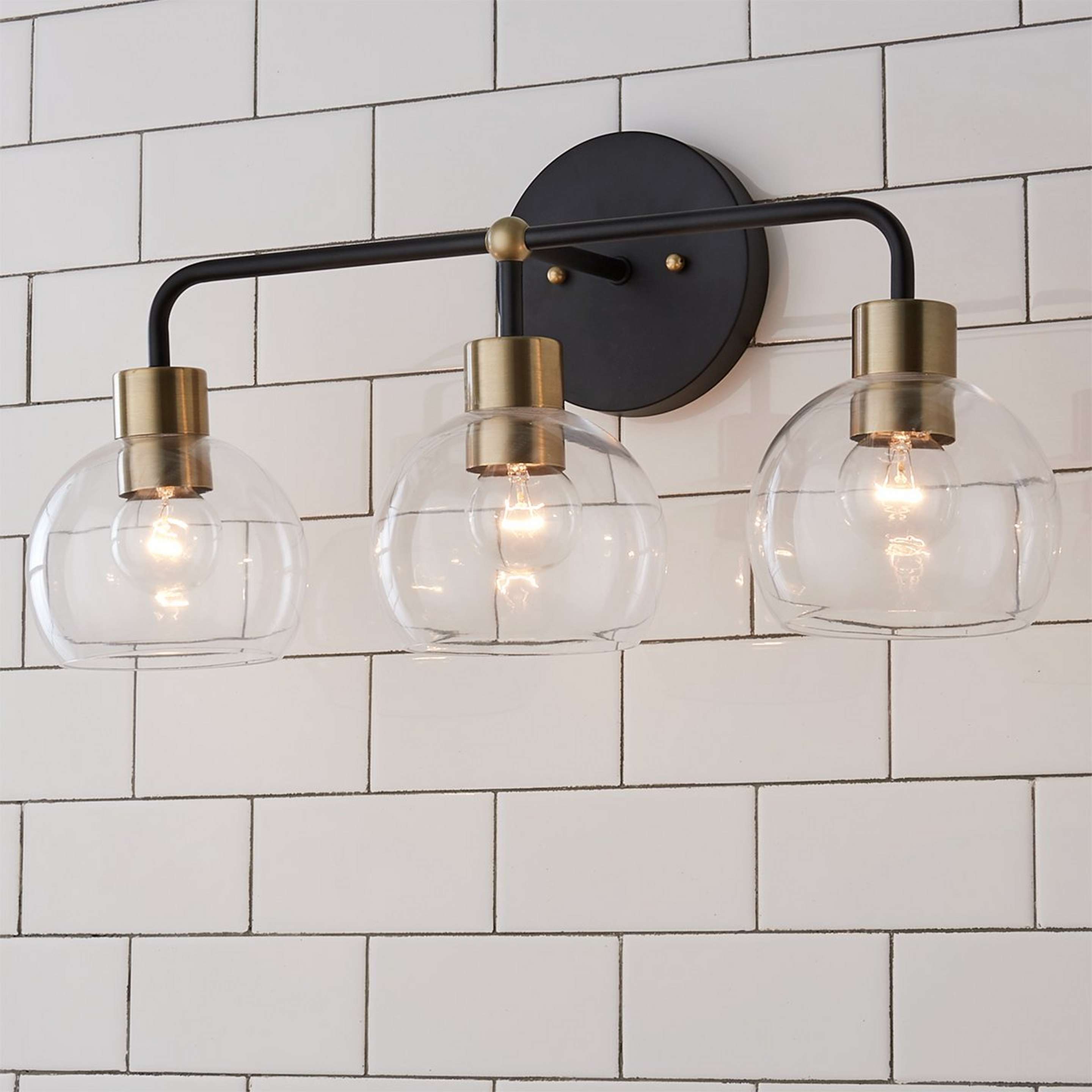 A Young House Love Clear Glass Bubble Vanity Light - 3 Light with Bronze / Clear Glass / Brass color
