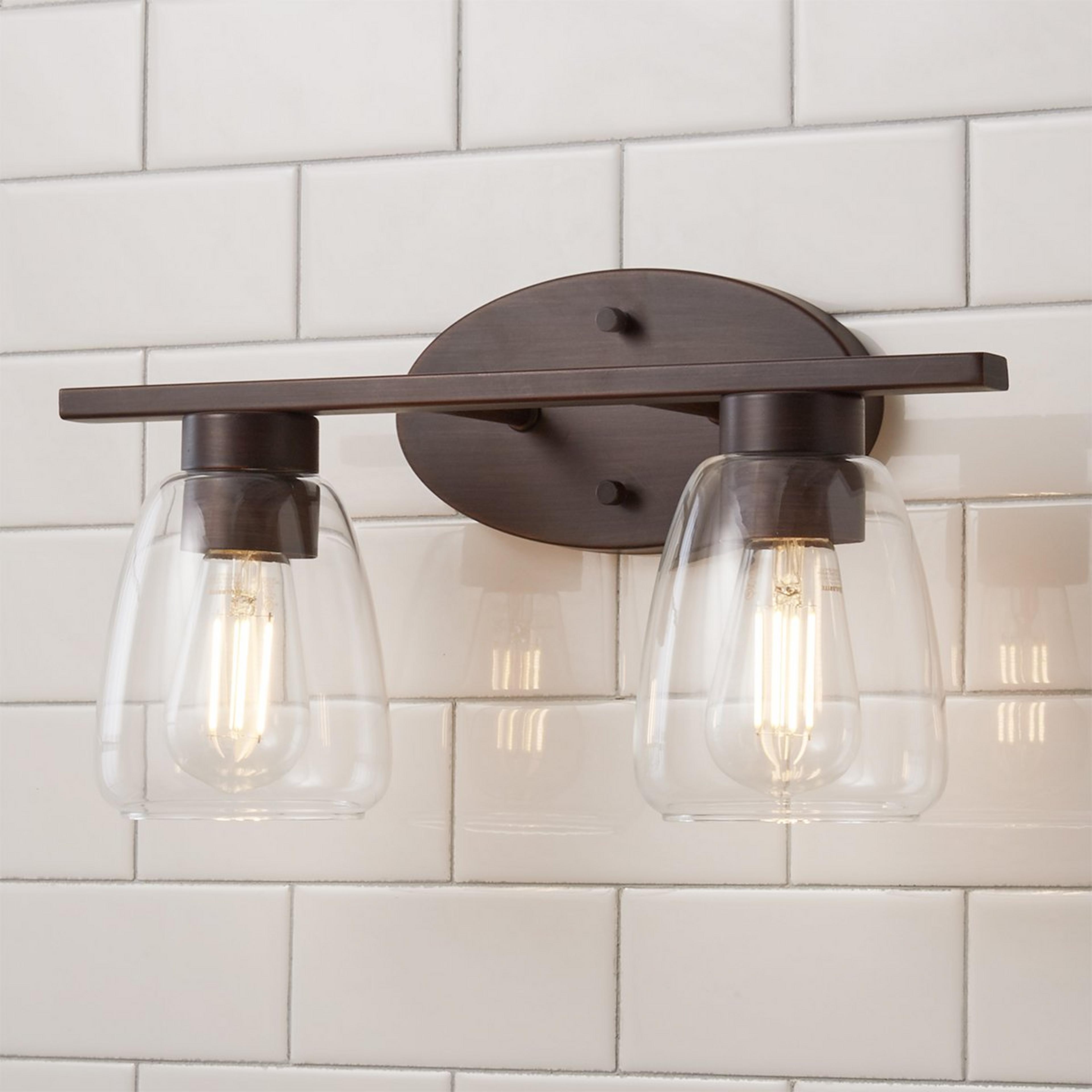 A Sleek Contemporary Vanity Light - 2 Light with Rubbed Bronze / Clear Glass color