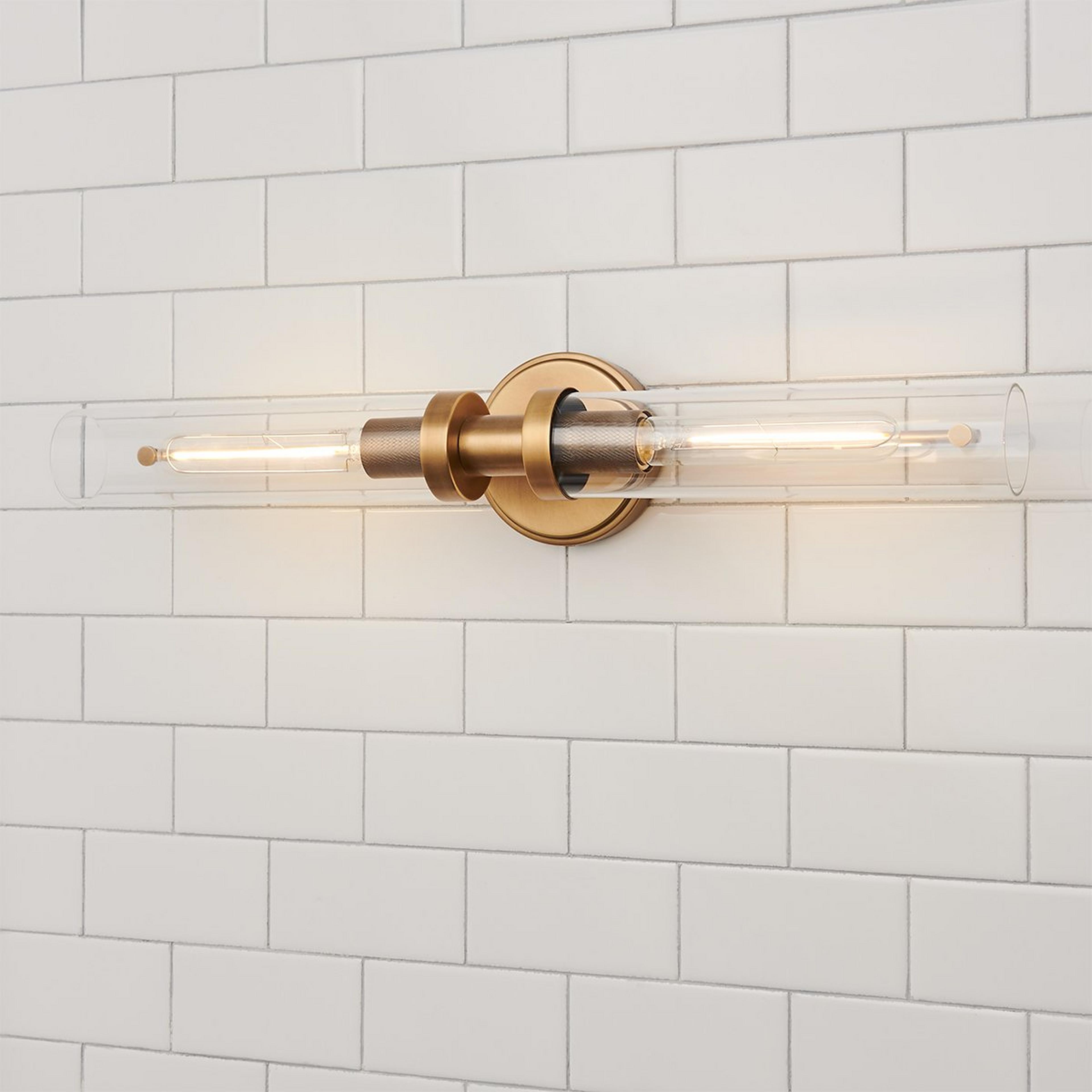 A Daphne Vanity Light with Aged Brass / Clear Glass color