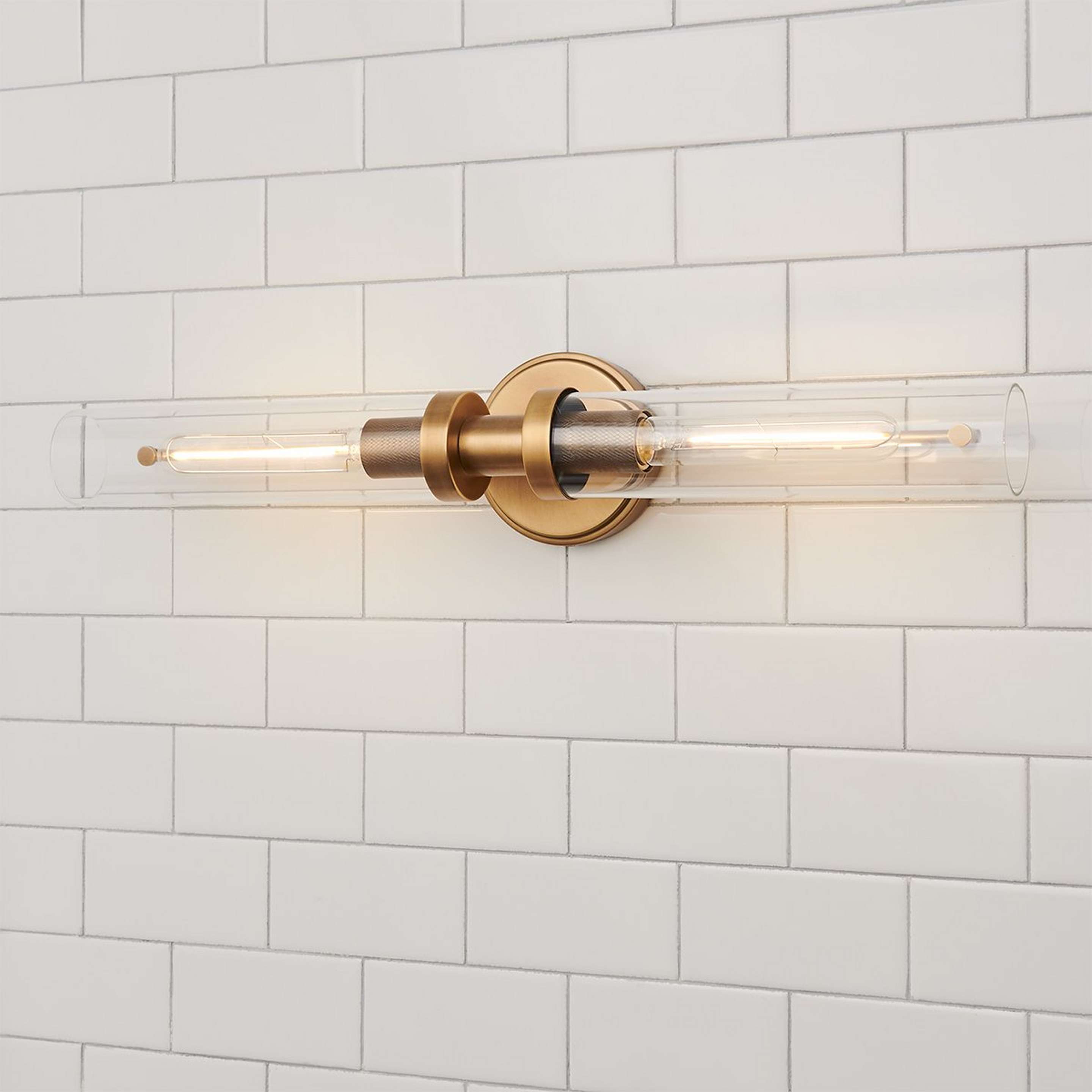 A Daphne Vanity Light with Aged Brass / Clear Glass color