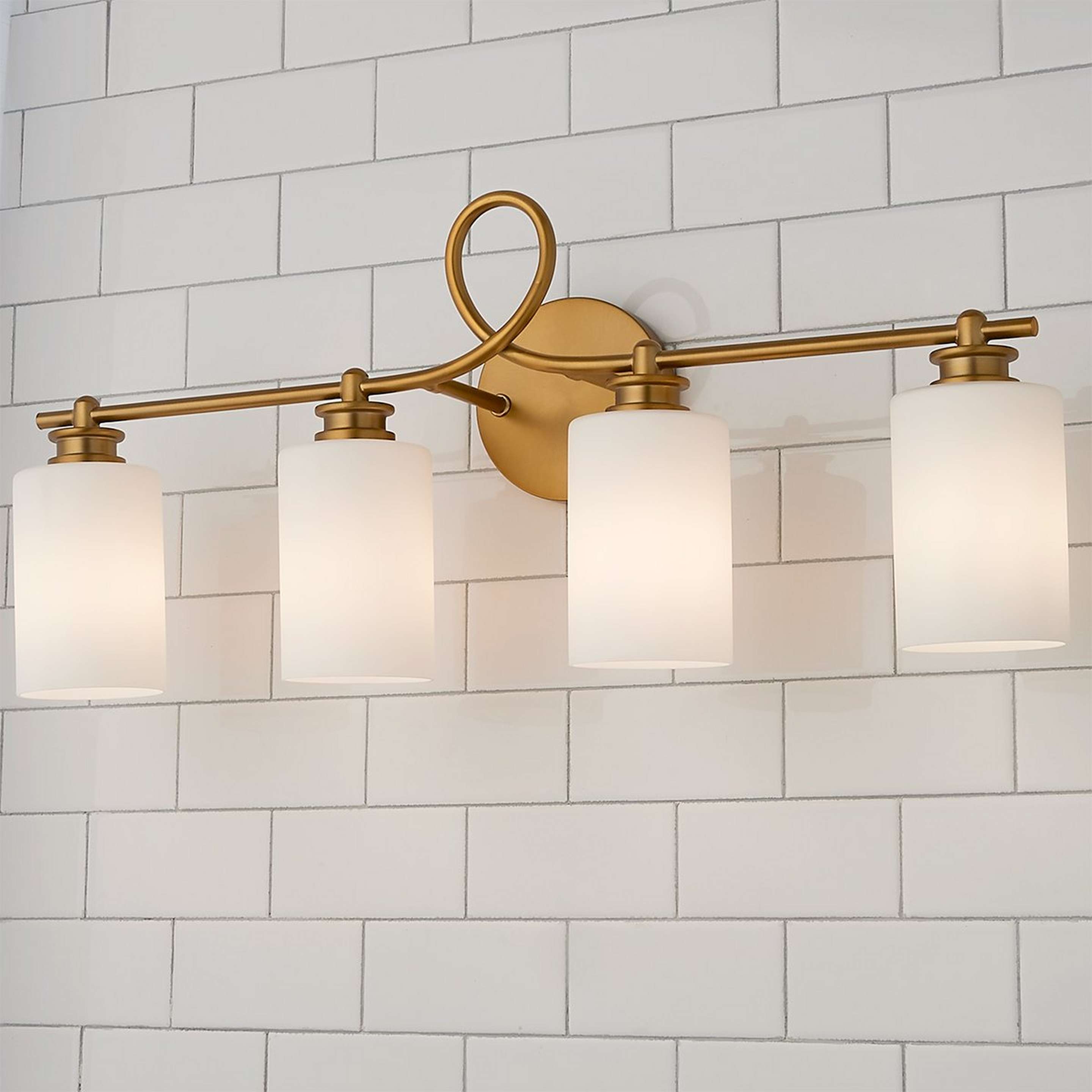 A Looped Arm Vanity Light - 4 Light with Aged Brass color