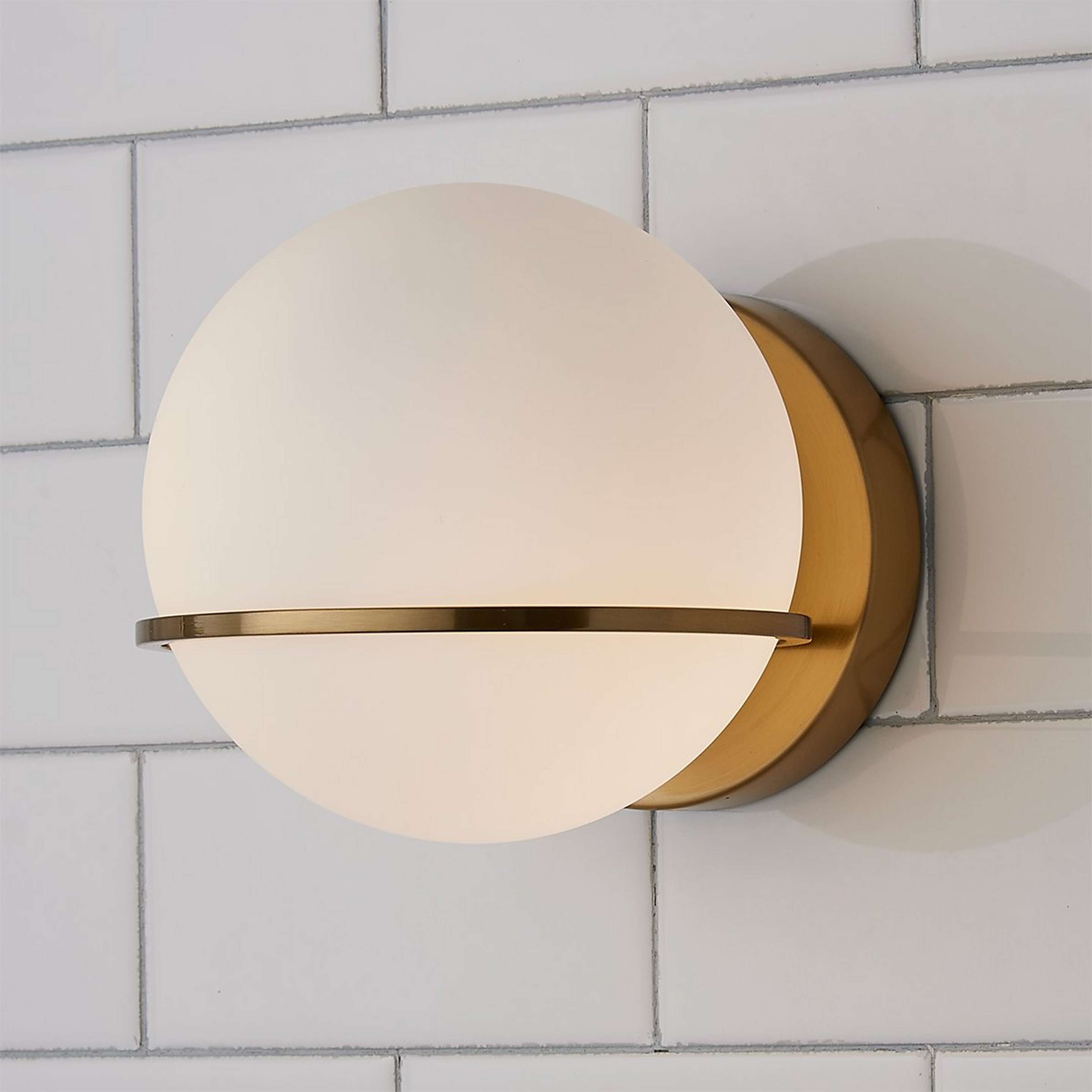 A Dario Bath Sconce with Aged Brass / White Opal Glass color